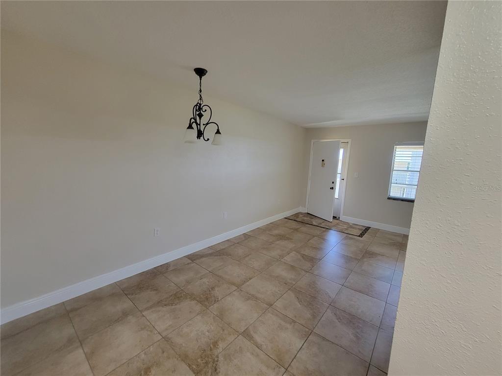 10032 65th Avenue North, Unit 19 St. Petersburg, FL 33708 - Photo 26 of 44 an empty room with a natural light