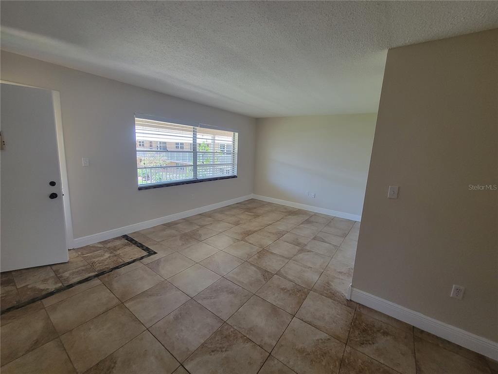 10032 65th Avenue North, Unit 19 St. Petersburg, FL 33708 - Photo 30 of 44 an empty room with windows