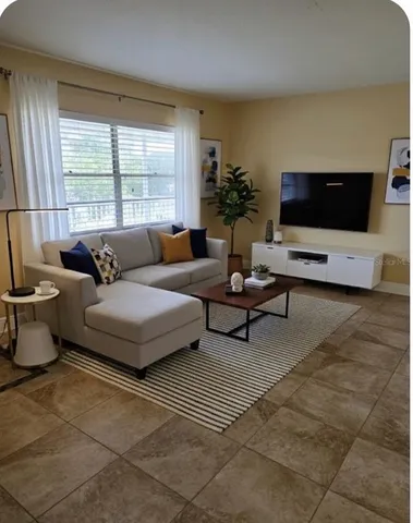 a living room with furniture and a flat screen tv