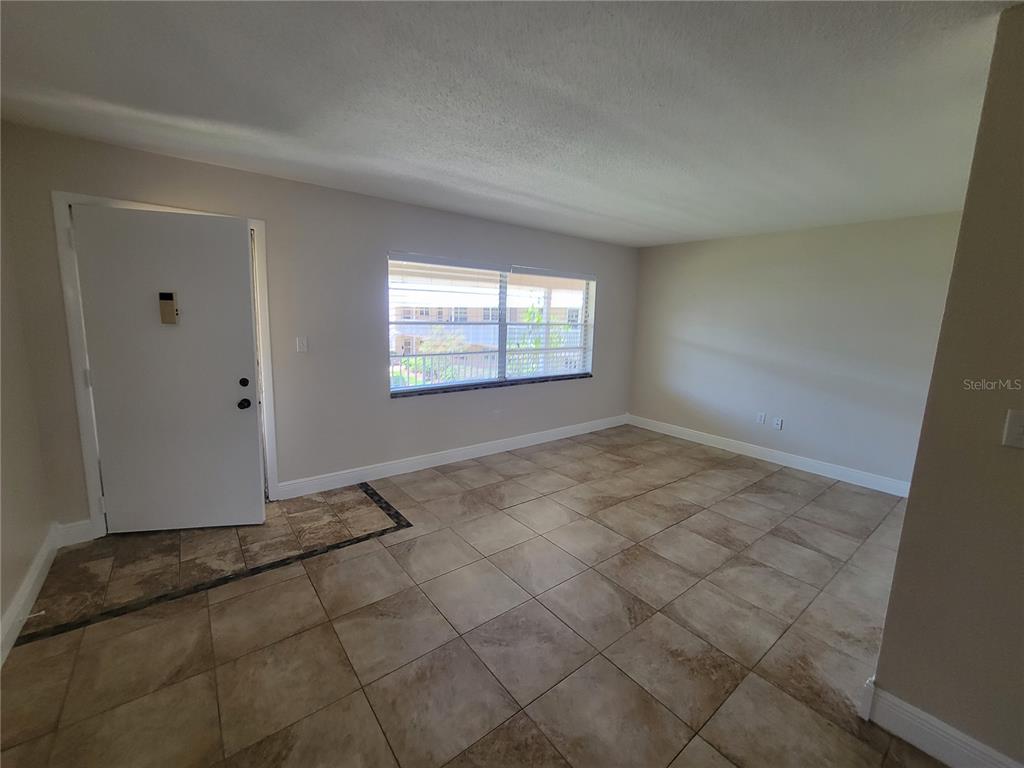 10032 65th Avenue North, Unit 19 St. Petersburg, FL 33708 - Photo 31 of 44 an empty room with windows