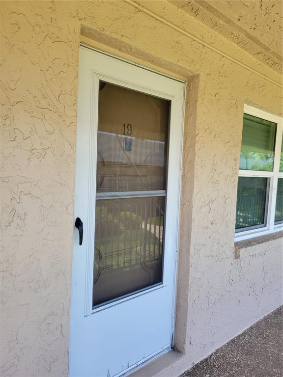 10032 65th Avenue North, Unit 19 St. Petersburg, FL 33708 - Photo 32 of 44 a view of front door of a house