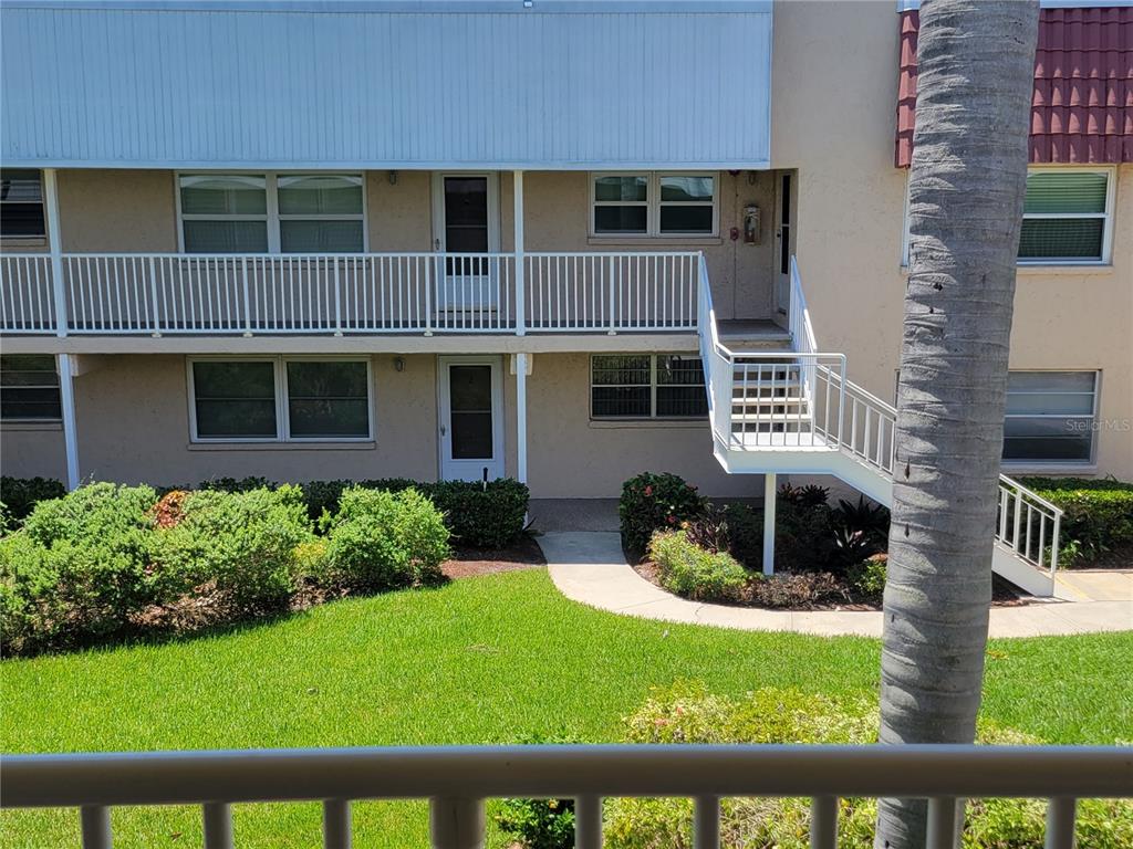 10032 65th Avenue North, Unit 19 St. Petersburg, FL 33708 - Photo 35 of 44 a front view of a house with garden