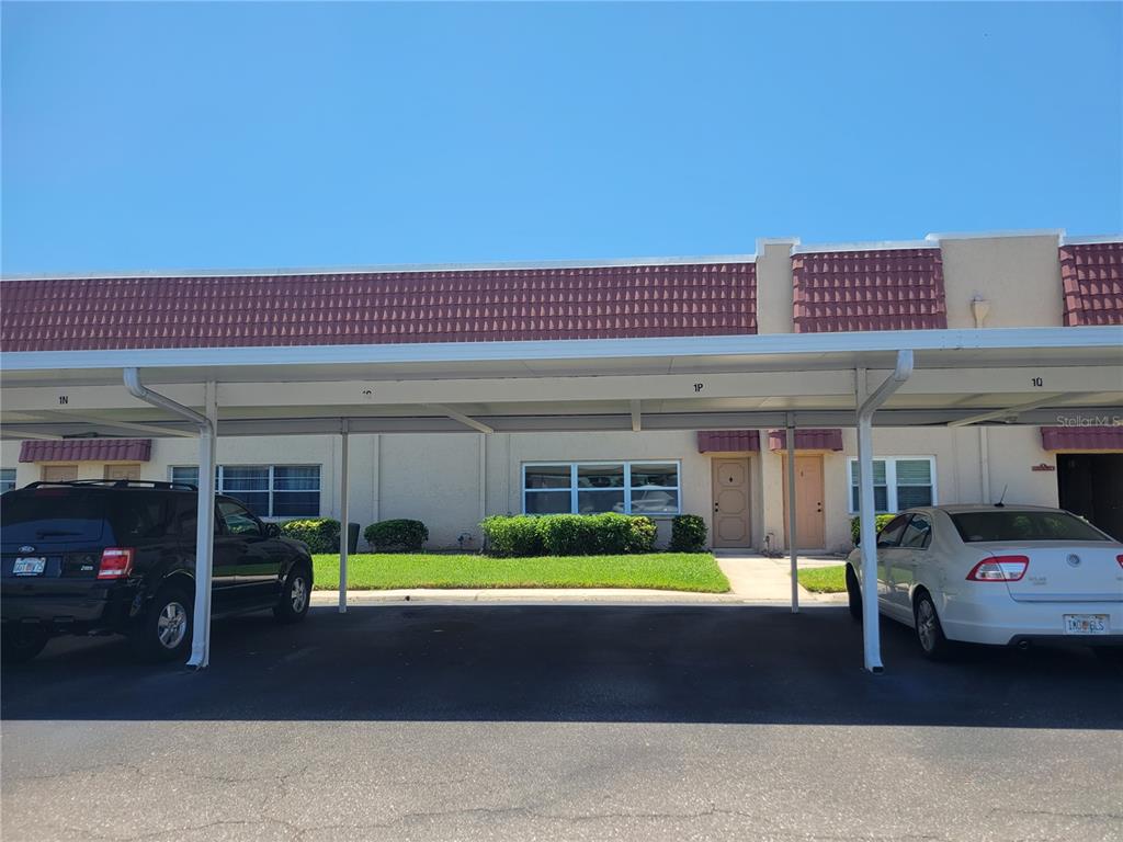 10032 65th Avenue North, Unit 19 St. Petersburg, FL 33708 - Photo 38 of 44 a front view of a building with glass windows