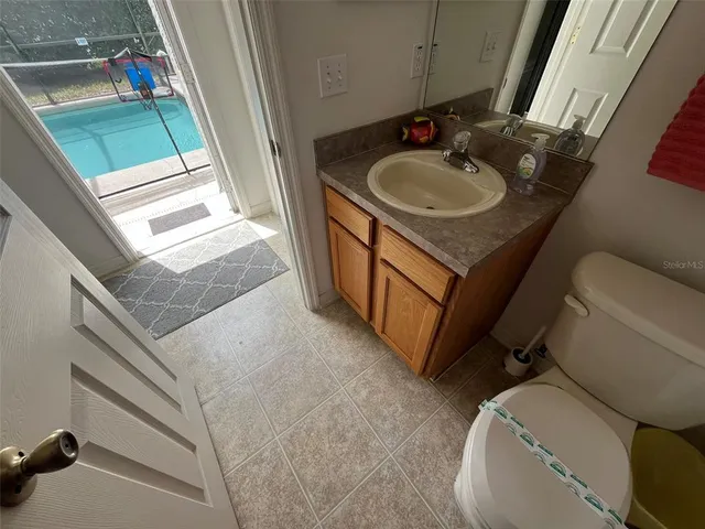 a bathroom with a sink toilet and a mirror