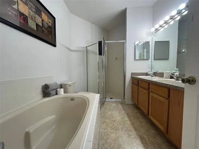 a bathroom with a tub sink and mirror