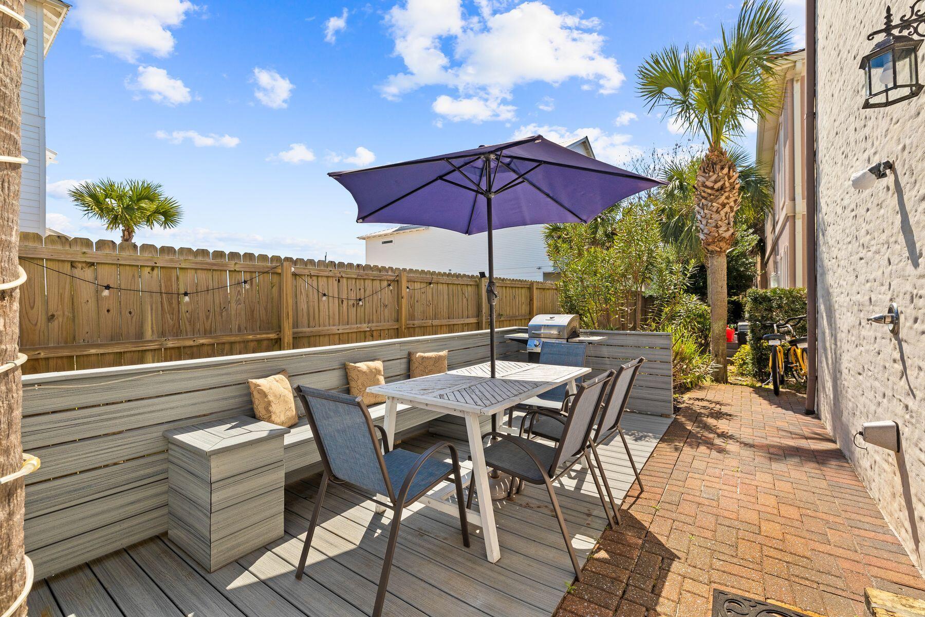 52 Le Soleil Drive Miramar Beach, FL 32550 - Photo 27 of 31 a view of a patio with a table and chairs under an umbrella