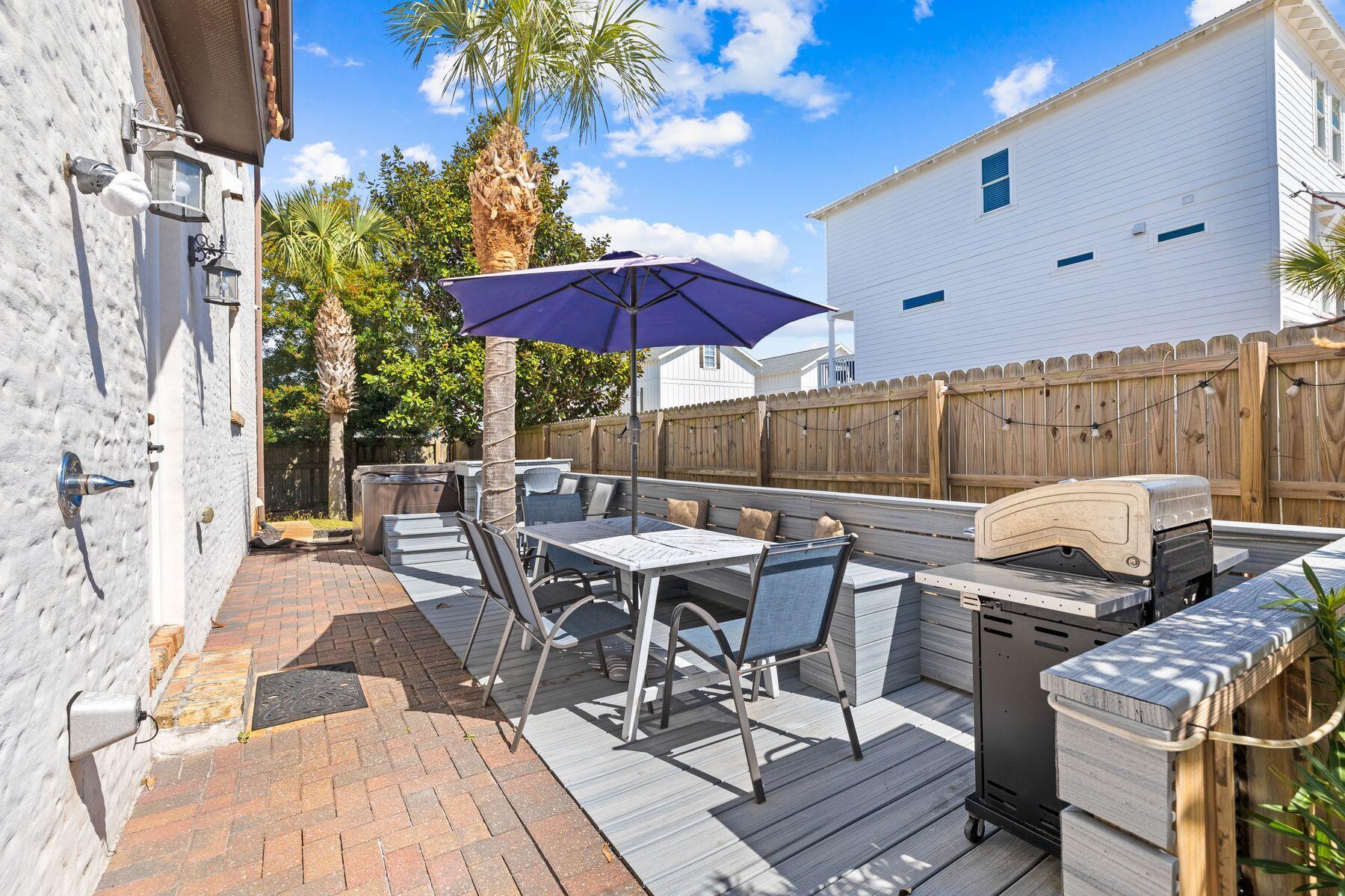 52 Le Soleil Drive Miramar Beach, FL 32550 - Photo 29 of 31 a view of a patio with a table and chairs under an umbrella