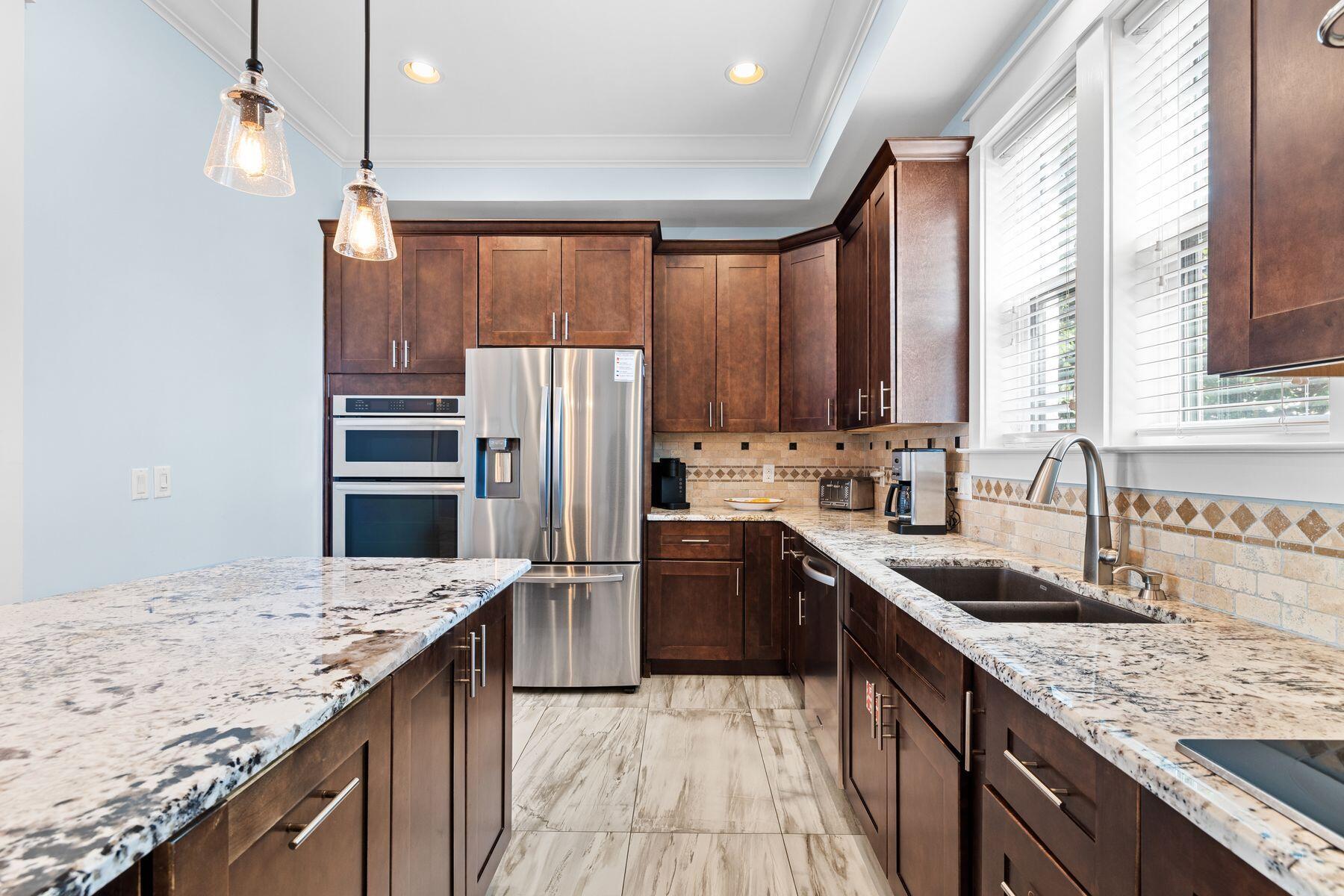 52 Le Soleil Drive Miramar Beach, FL 32550 - Photo 5 of 31 a kitchen with stainless steel appliances granite countertop a sink stove and refrigerator