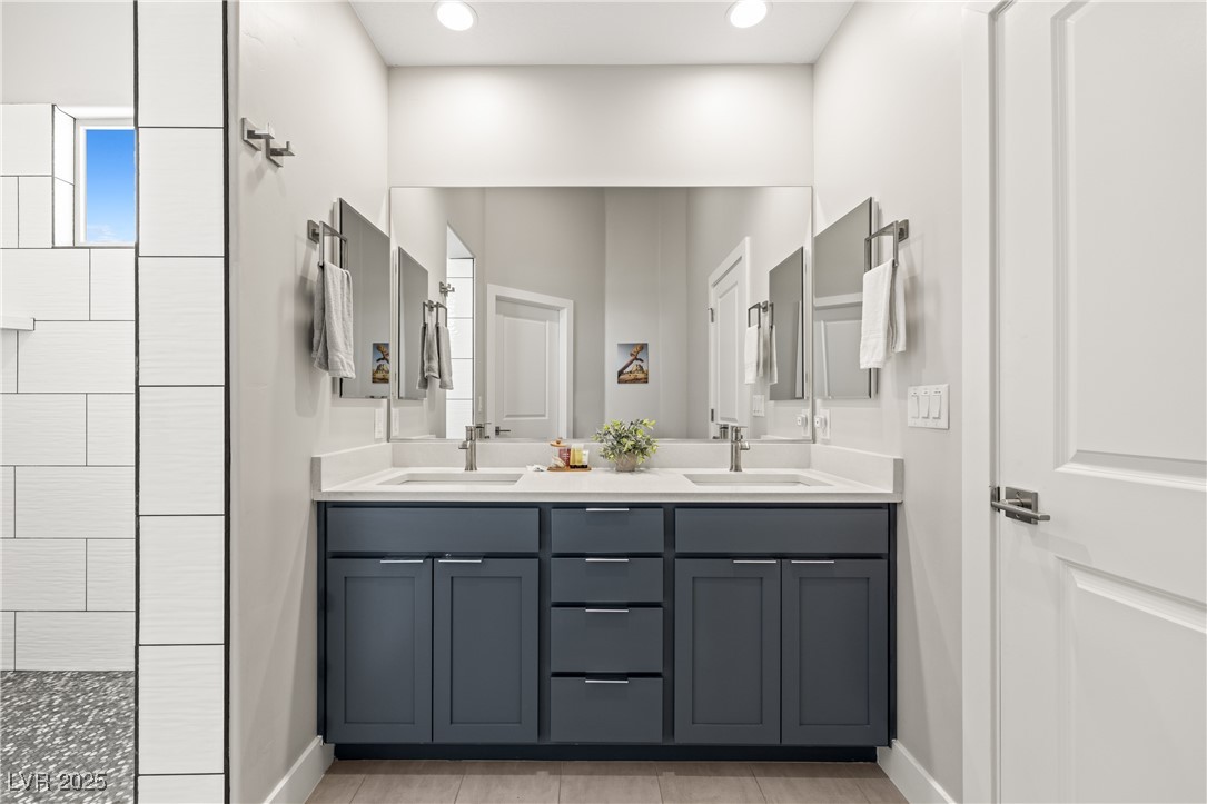 1357 Manassas Ridge Mesquite, NV 89027 - Photo 14 of 72 Full bath with double vanity, baseboards, a tile shower, recessed lighting, and tile patterned flooring