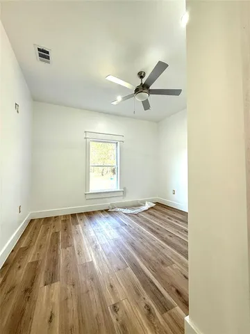 a view of an empty room and wooden floor