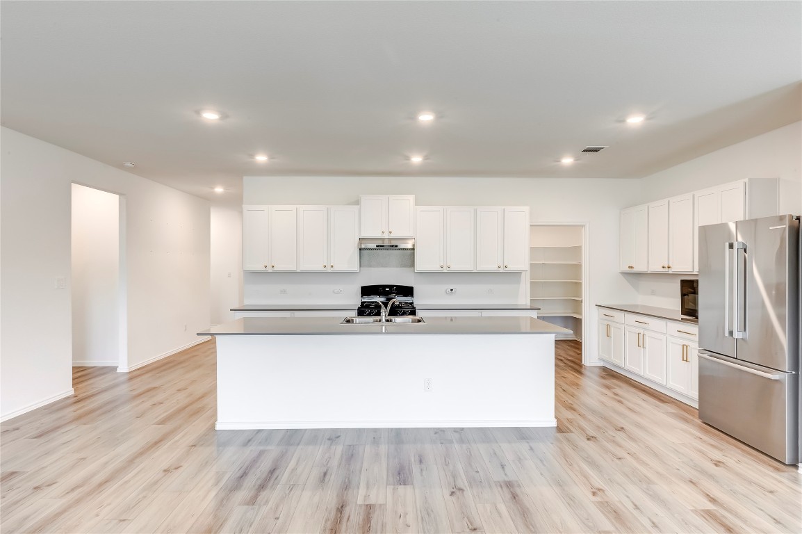 2113 Guntersville Bend Leander, TX 78641 - Photo 11 of 40 a large kitchen with stainless steel appliances and a refrigerator