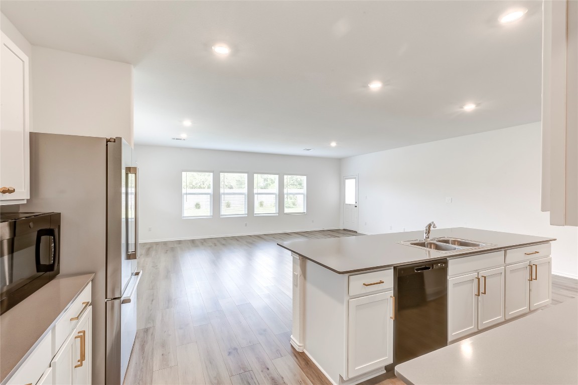 2113 Guntersville Bend Leander, TX 78641 - Photo 15 of 40 a kitchen that has a sink a stove and wooden floor