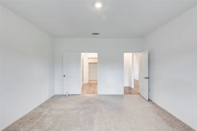 a spacious bathroom with a double vanity sink a mirror and a shower