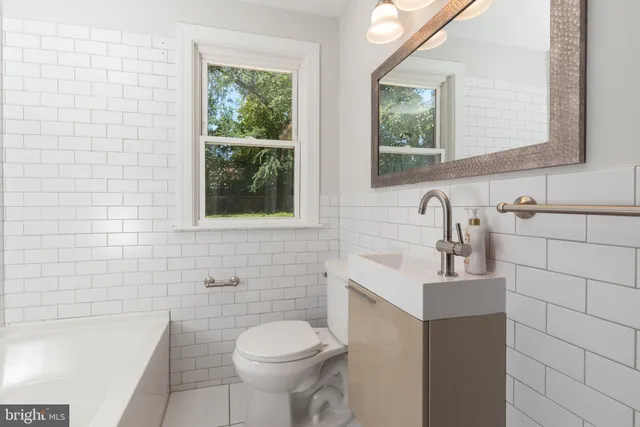 a bathroom with a sink a toilet and window