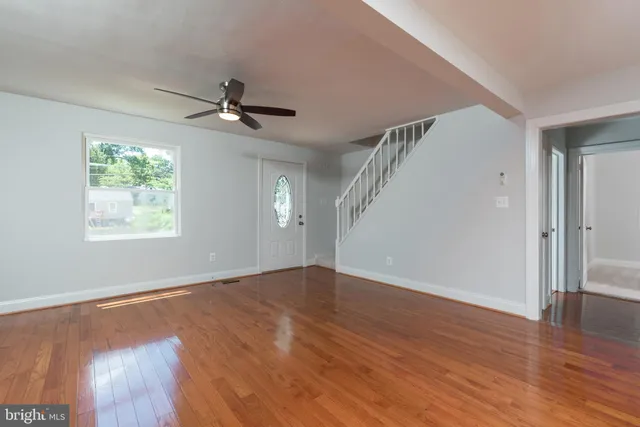 wooden floor in an empty room with a window