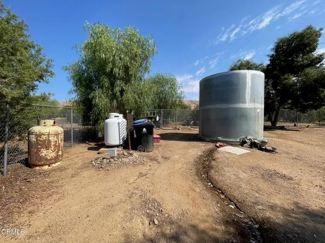 a view of a patio with table and chairs with wooden fence and plants