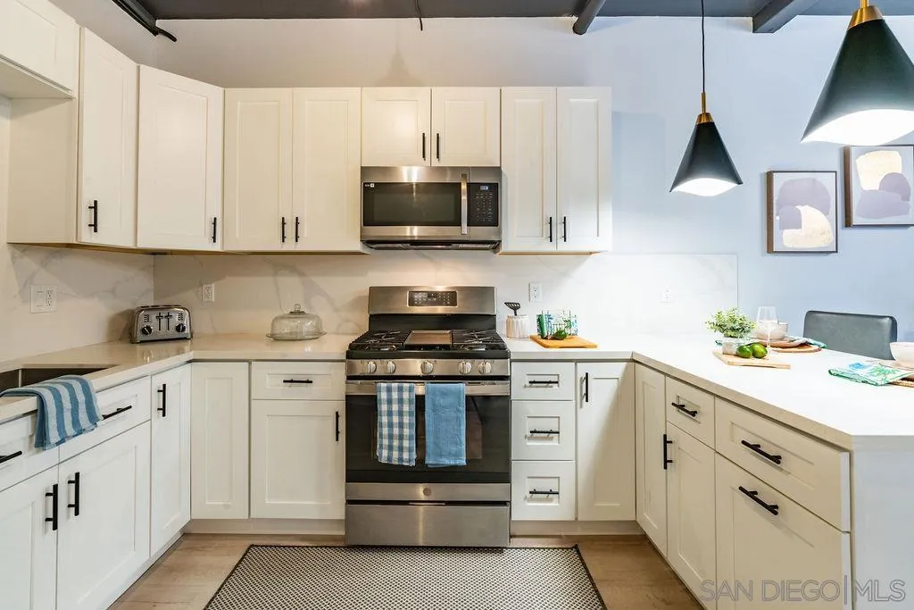 1298 Prospect Street, Unit 2F La Jolla, CA 92037 - Photo 11 of 54 a kitchen with white cabinets and appliances