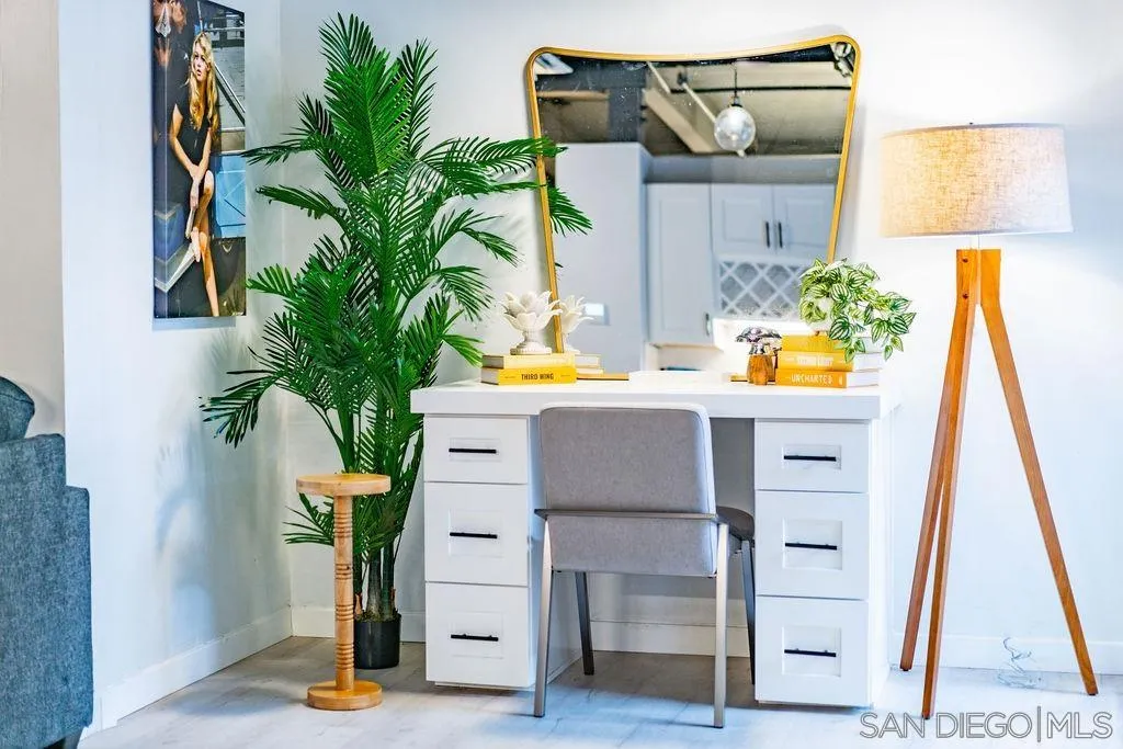 1298 Prospect Street, Unit 2F La Jolla, CA 92037 - Photo 15 of 54 a table with a potted plant on it and a wooden floor