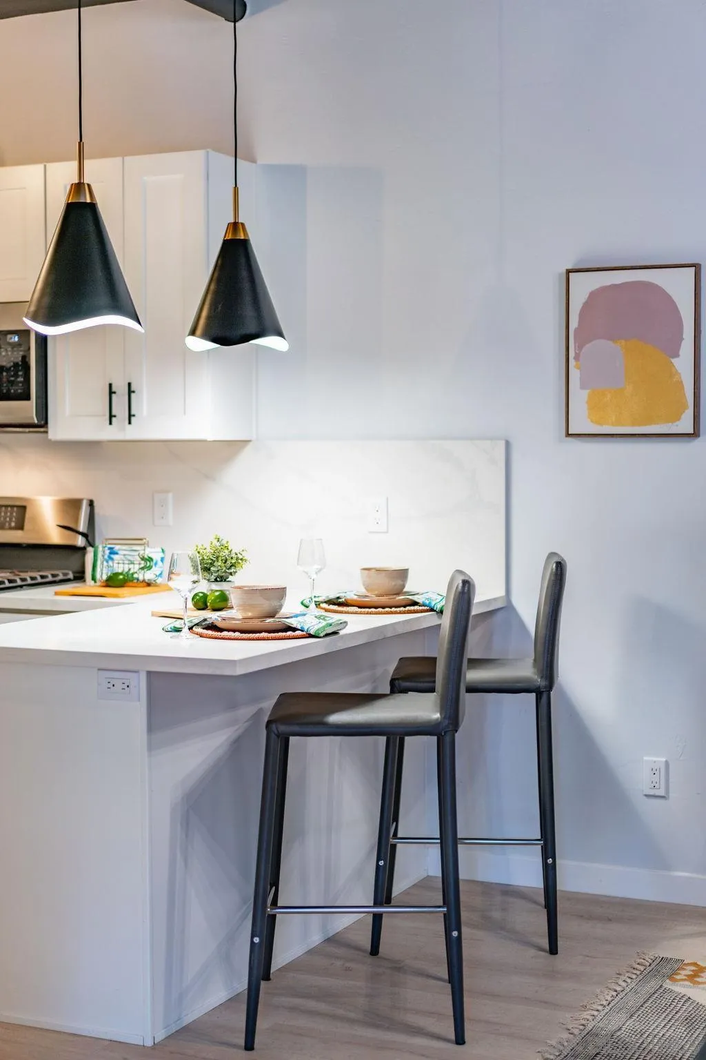 1298 Prospect Street, Unit 2F La Jolla, CA 92037 - Photo 16 of 54 a kitchen with stainless steel appliances granite countertop a dining table chairs and white cabinets