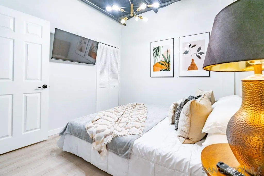 1298 Prospect Street, Unit 2F La Jolla, CA 92037 - Photo 19 of 54 a bedroom with a bed and a painting on the wall