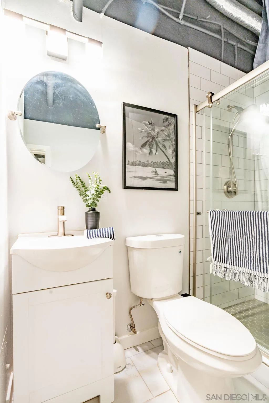 1298 Prospect Street, Unit 2F La Jolla, CA 92037 - Photo 23 of 54 a white toilet sitting next to a bathroom sink and tub