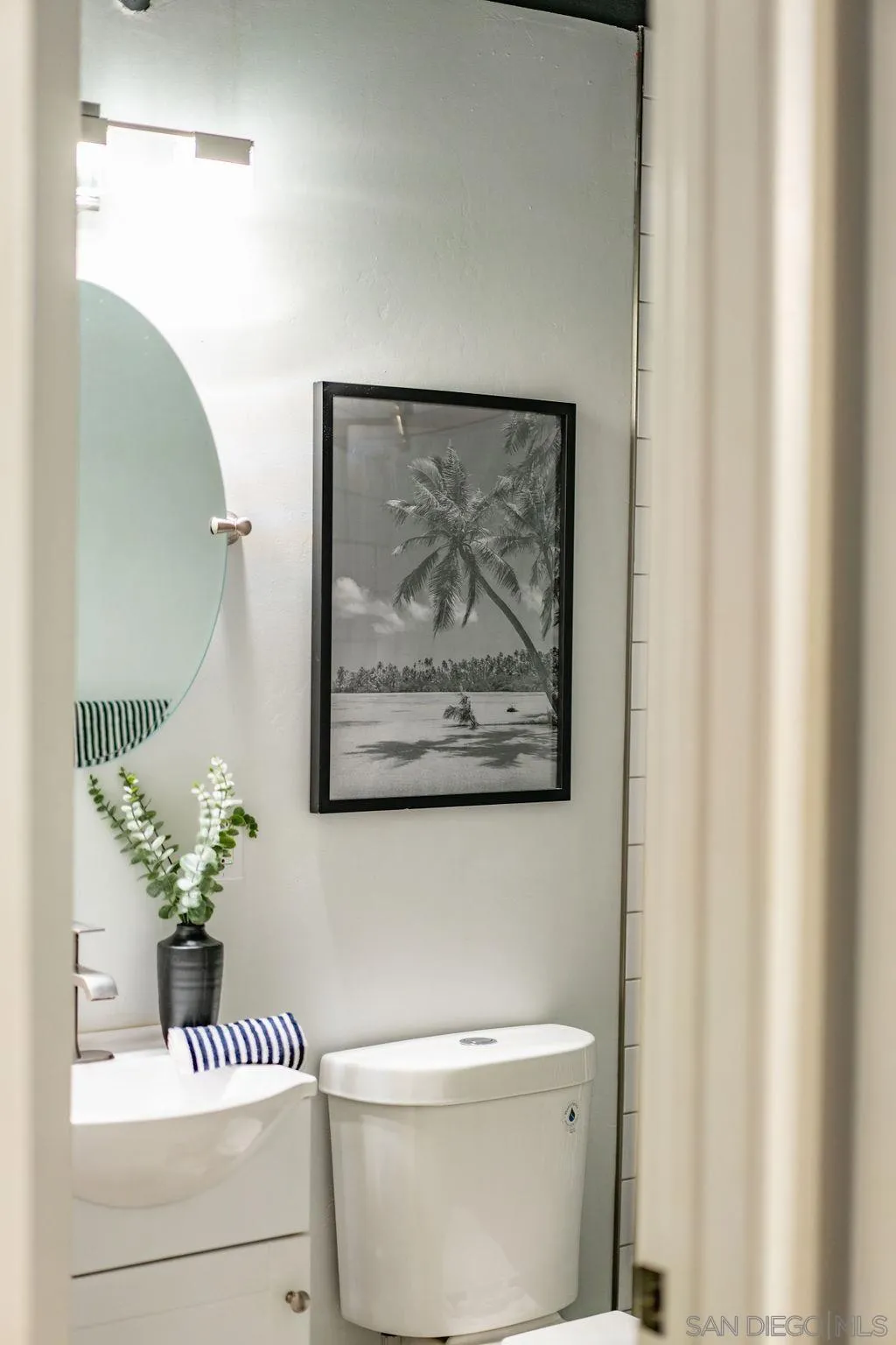 1298 Prospect Street, Unit 2F La Jolla, CA 92037 - Photo 29 of 54 a bathroom with a toilet a sink and a mirror
