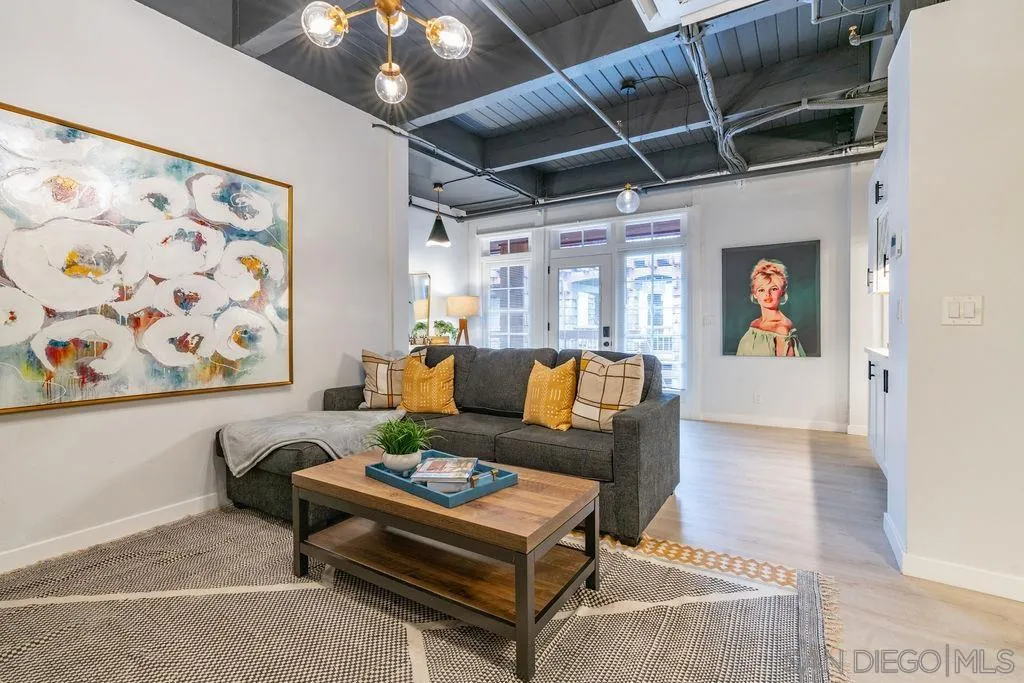 1298 Prospect Street, Unit 2F La Jolla, CA 92037 - Photo 9 of 54 a living room with furniture and a chandelier