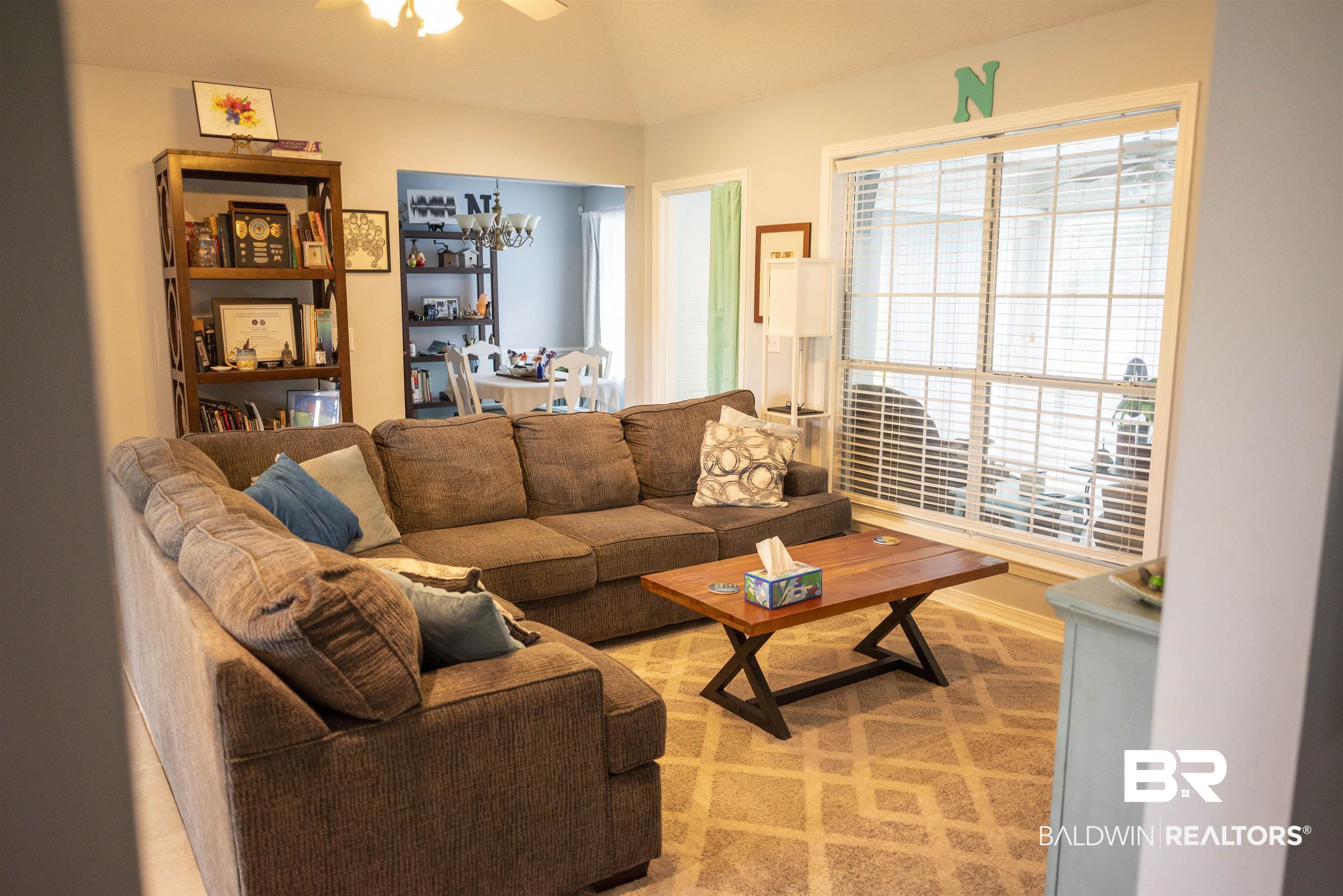 808 Wisteria Lane Foley, AL 36535 - Photo 5 of 19 Carpeted living room with ceiling fan with notable chandelier