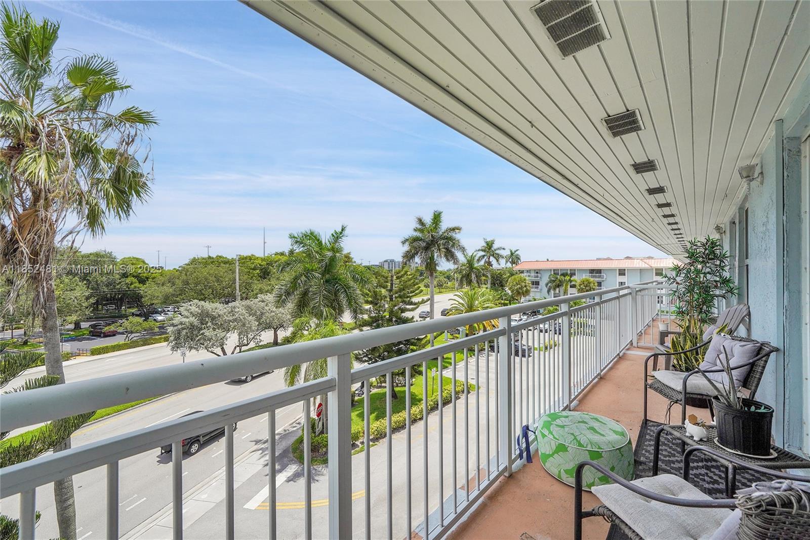 405 South Pine Island Road, Unit 403D Plantation, FL 33324 - Photo 12 of 20 a balcony with wooden floor and outdoor space