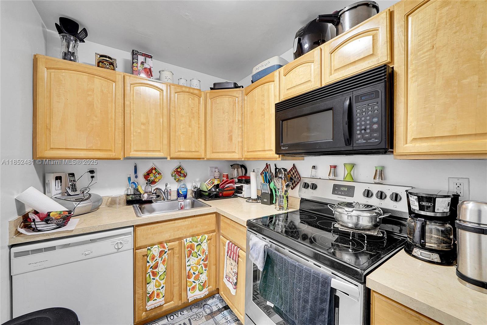 405 South Pine Island Road, Unit 403D Plantation, FL 33324 - Photo 7 of 20 a kitchen with stainless steel appliances a stove a sink dishwasher and cabinets with wooden floor