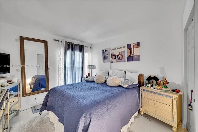 a bedroom with a bed and a tv