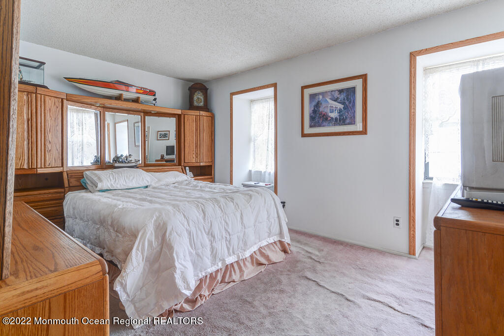 494 Rena Court Brick, NJ 08724 - Photo 11 of 18 a spacious bedroom with a bed and a flat screen tv