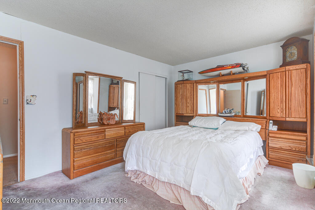 494 Rena Court Brick, NJ 08724 - Photo 13 of 18 a bedroom with a bed and window with couch