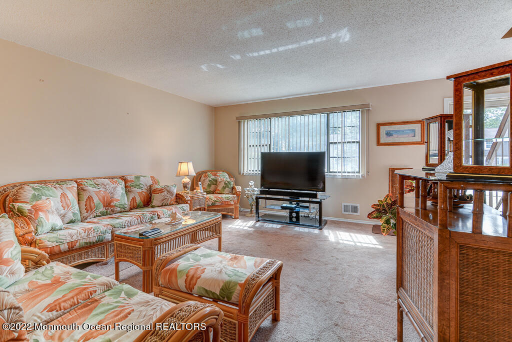 494 Rena Court Brick, NJ 08724 - Photo 5 of 18 a living room with furniture and a flat screen tv
