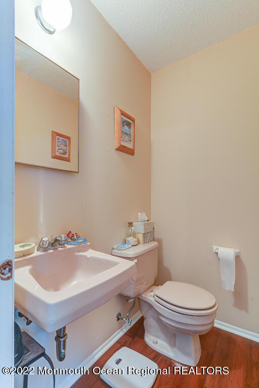 494 Rena Court Brick, NJ 08724 - Photo 10 of 18 a bathroom with a sink a toilet and a mirror