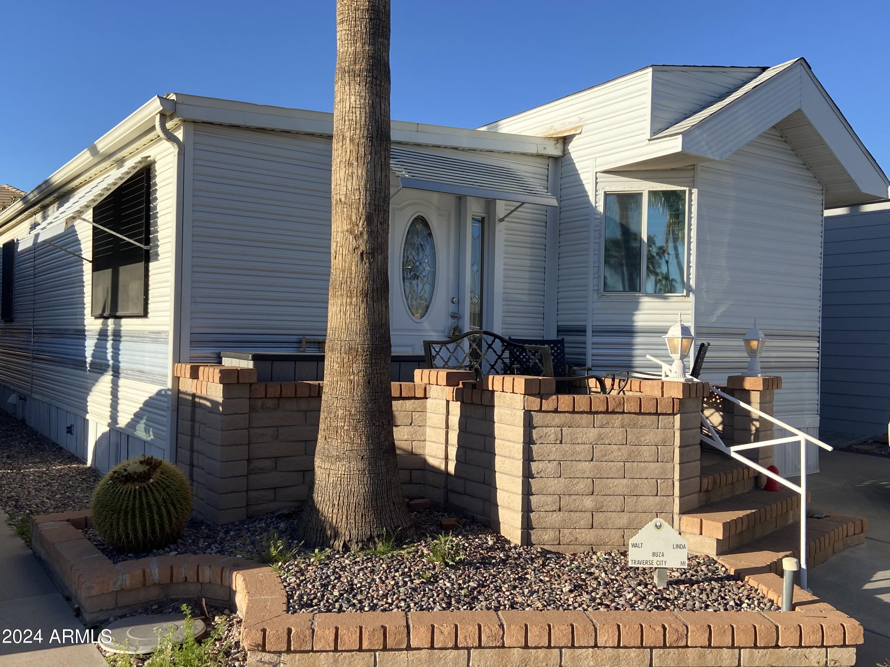 2066 West Klamath Avenue, Unit 66 Apache Junction, AZ 85119 - Photo 1 of 35 a front view of a house with garden