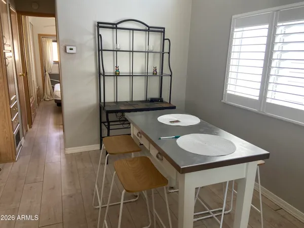 a bathroom with a white shower and a window of another room