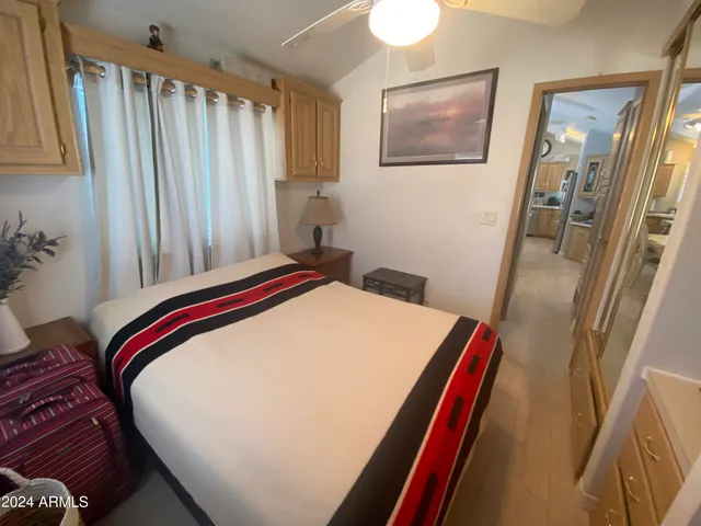 a bedroom with a bed and a chandelier