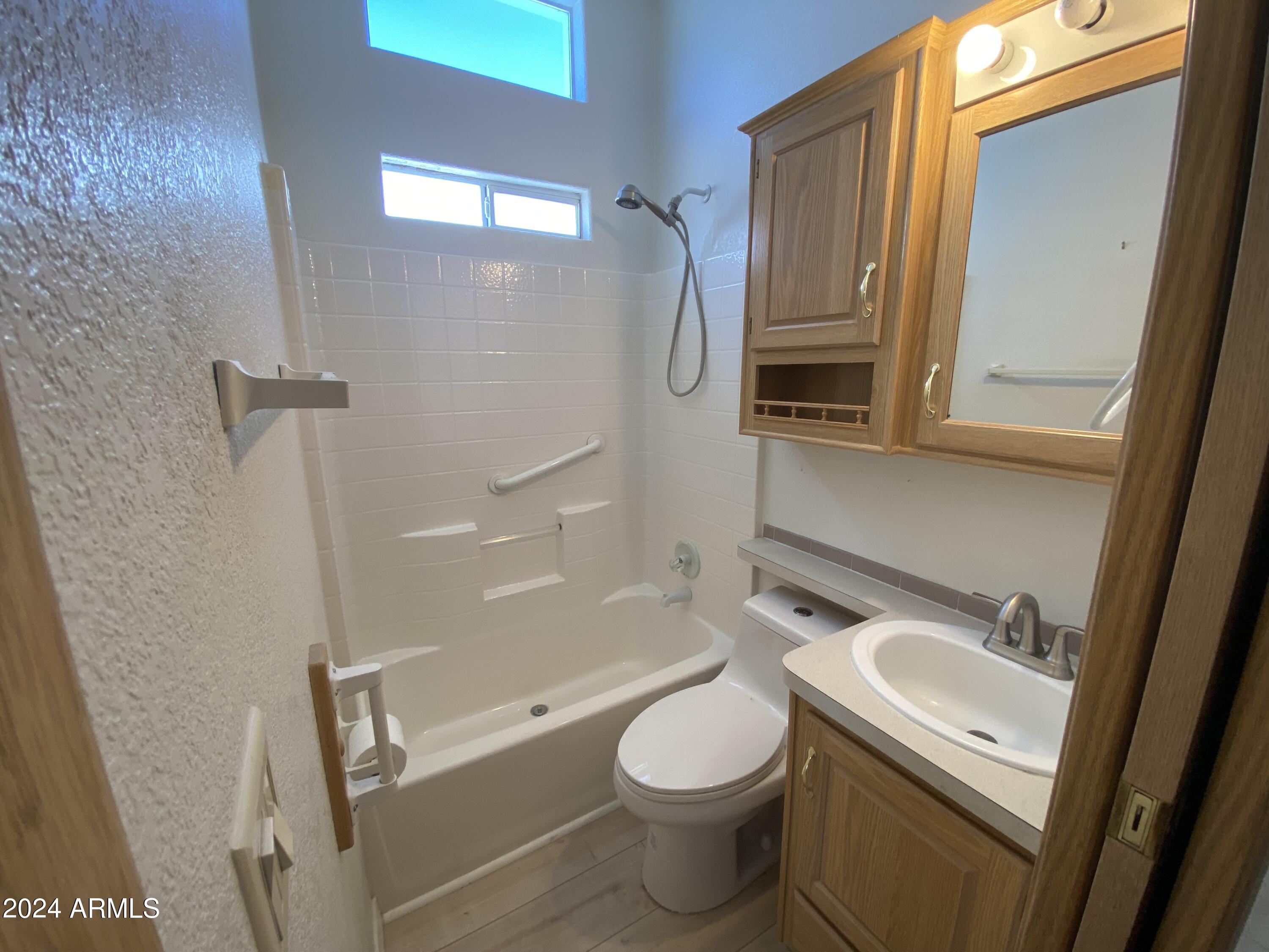 2066 West Klamath Avenue, Unit 66 Apache Junction, AZ 85119 - Photo 17 of 35 a bathroom with a sink a toilet and shower