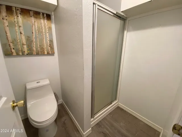 a bathroom with a sink and mirror with toilet