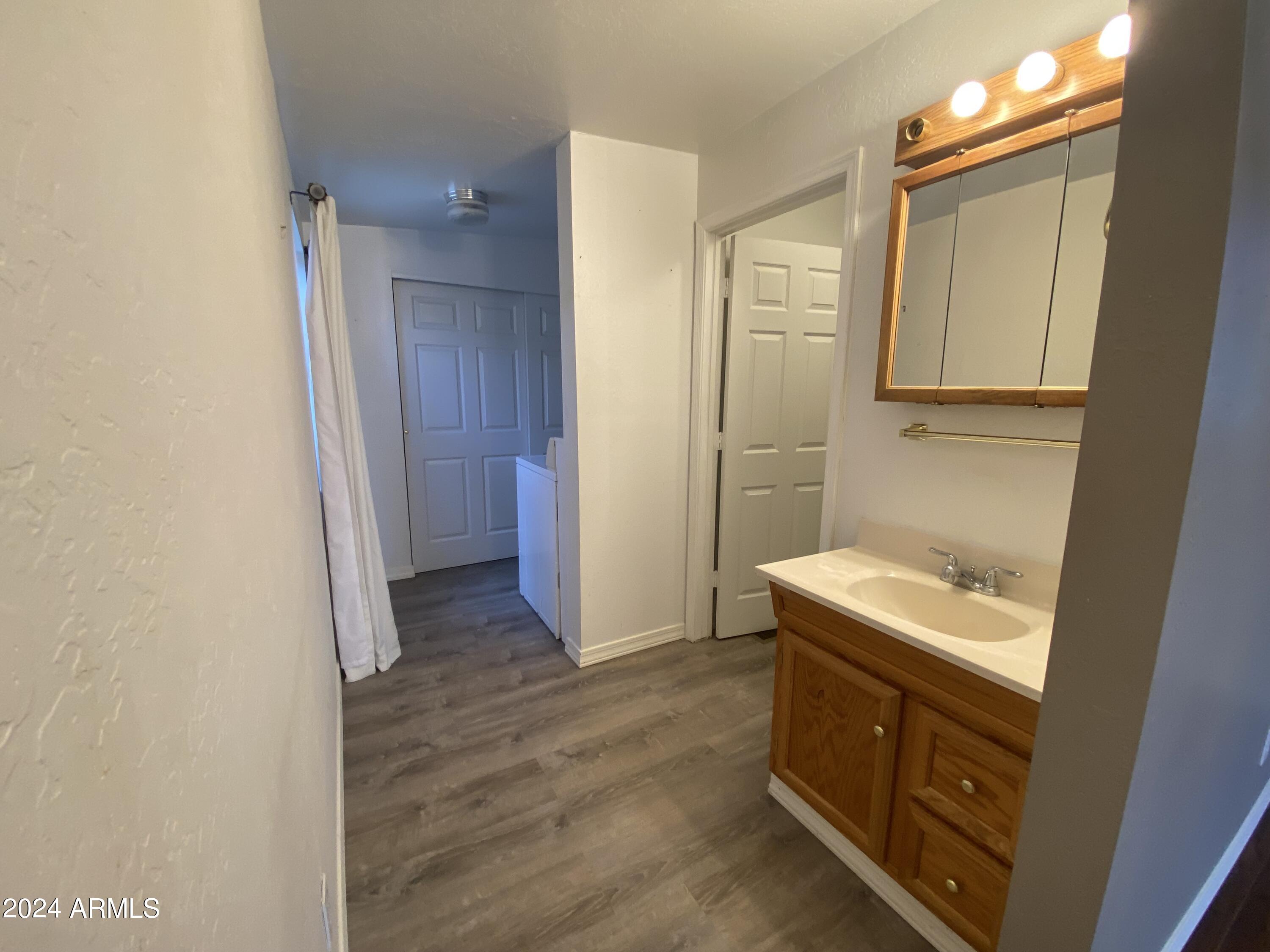 2066 West Klamath Avenue, Unit 66 Apache Junction, AZ 85119 - Photo 24 of 35 a bathroom with a sink and a mirror