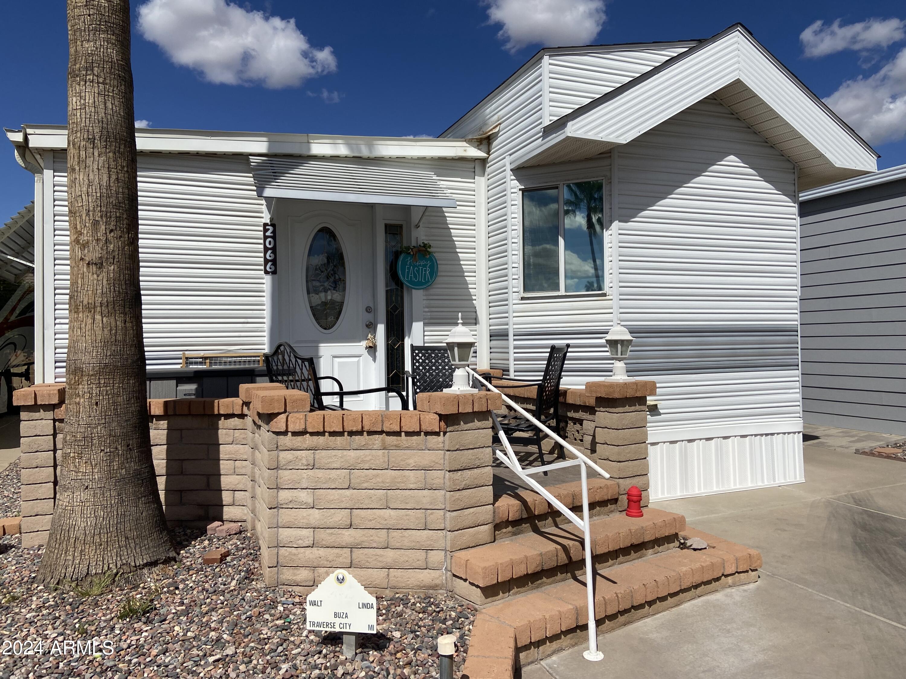 2066 West Klamath Avenue, Unit 66 Apache Junction, AZ 85119 - Photo 25 of 35 a front view of a house with patio