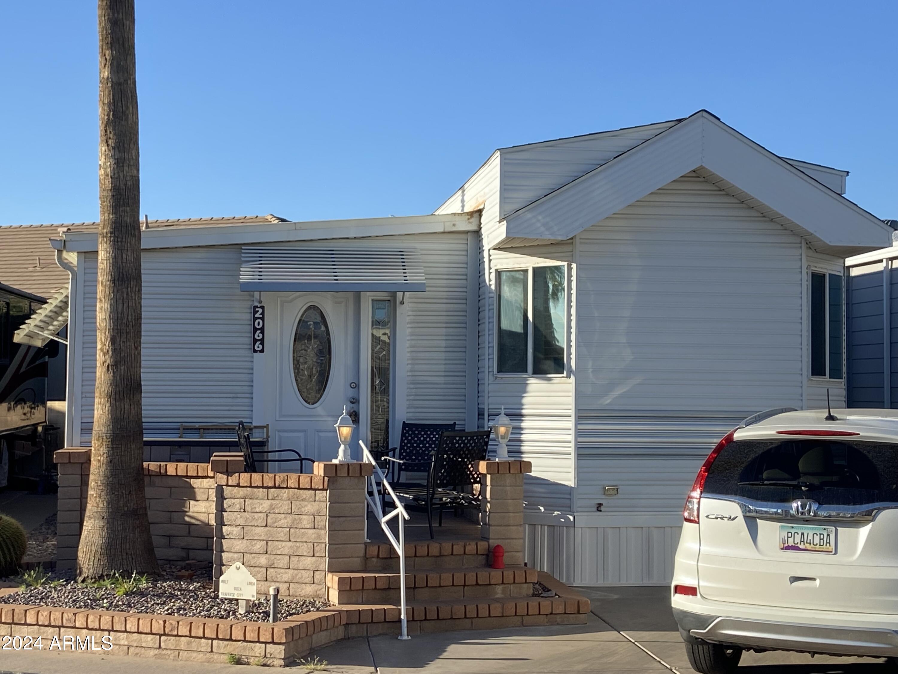 2066 West Klamath Avenue, Unit 66 Apache Junction, AZ 85119 - Photo 26 of 35 a front view of a house with parking