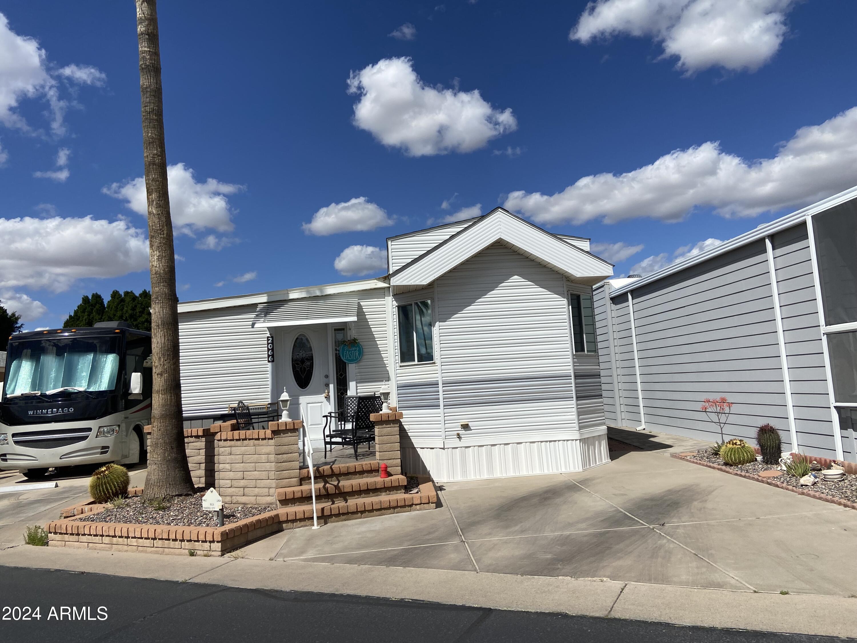 2066 West Klamath Avenue, Unit 66 Apache Junction, AZ 85119 - Photo 30 of 35 a view of a house with a patio