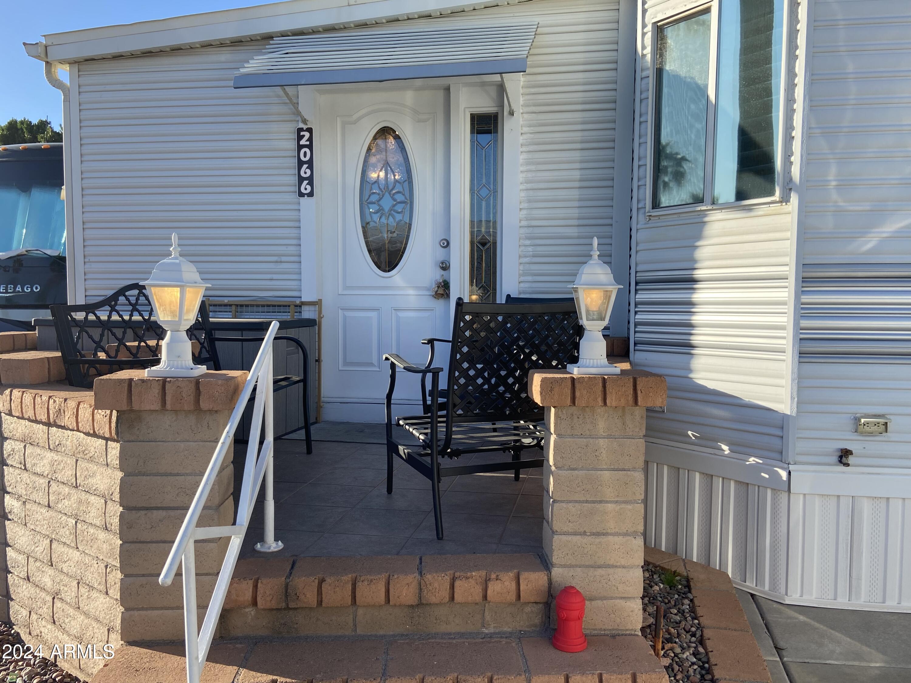 2066 West Klamath Avenue, Unit 66 Apache Junction, AZ 85119 - Photo 33 of 35 a view of entryway and hall with outdoor seating