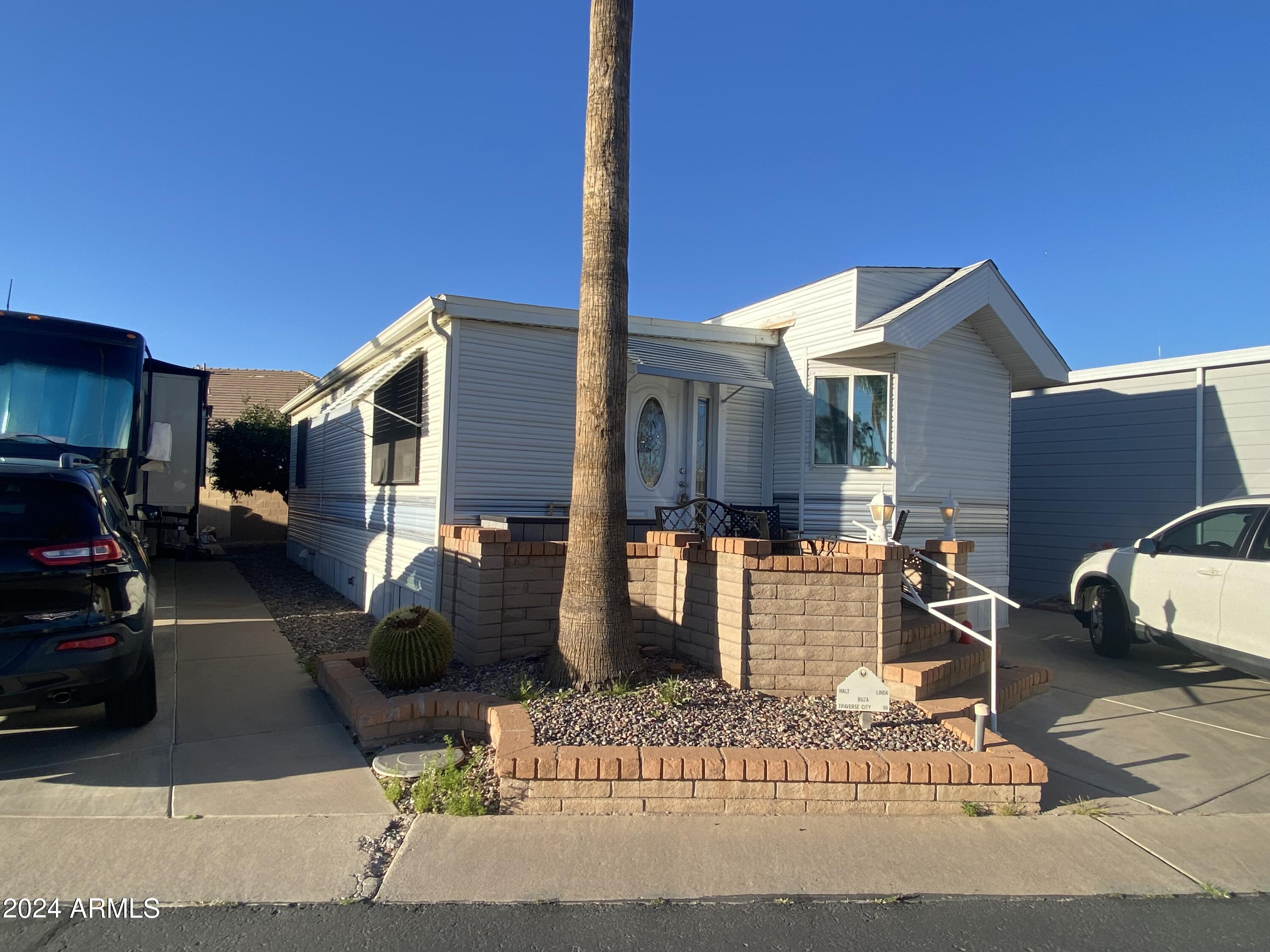 2066 West Klamath Avenue, Unit 66 Apache Junction, AZ 85119 - Photo 34 of 35 a street view with couple of cars parked on road