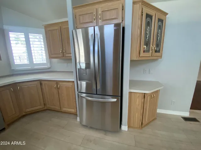 a kitchen with stainless steel appliances granite countertop a refrigerator and a sink