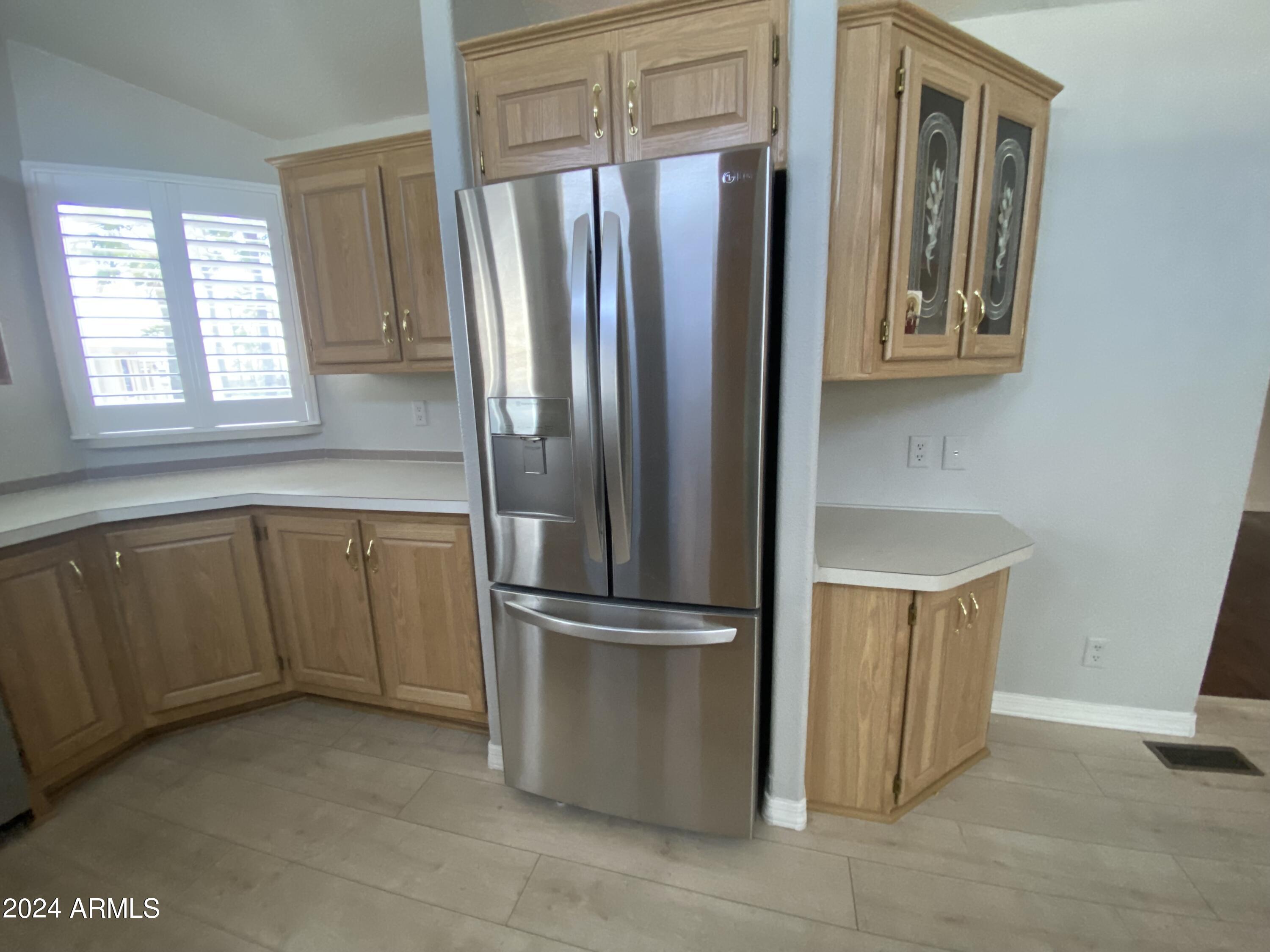 2066 West Klamath Avenue, Unit 66 Apache Junction, AZ 85119 - Photo 4 of 35 a kitchen with stainless steel appliances granite countertop a refrigerator and a sink