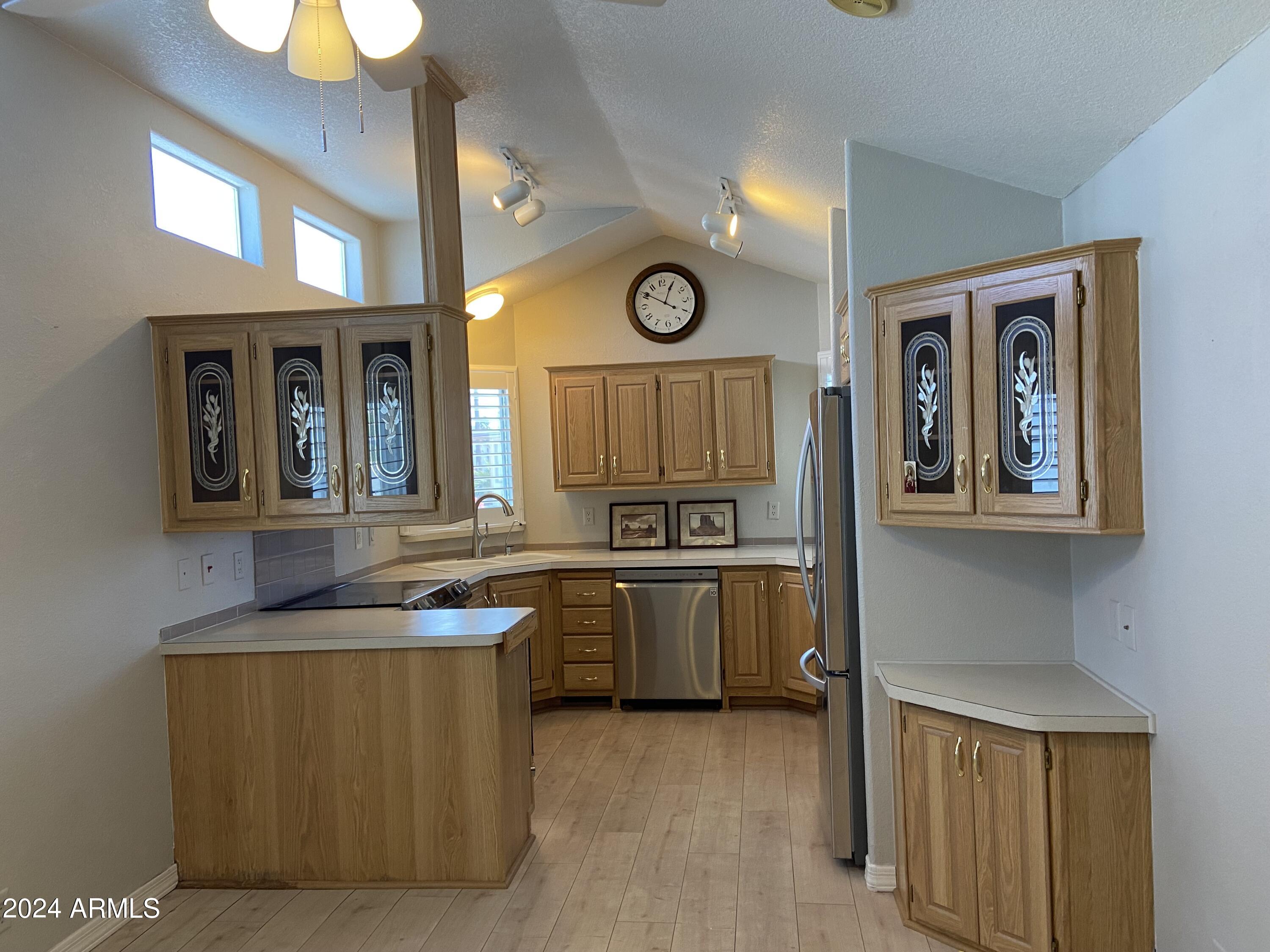 2066 West Klamath Avenue, Unit 66 Apache Junction, AZ 85119 - Photo 5 of 35 a kitchen with granite countertop a sink a stove top oven and cabinetry