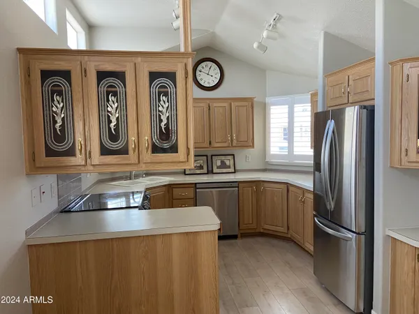 a kitchen with stainless steel appliances granite countertop a refrigerator and a sink